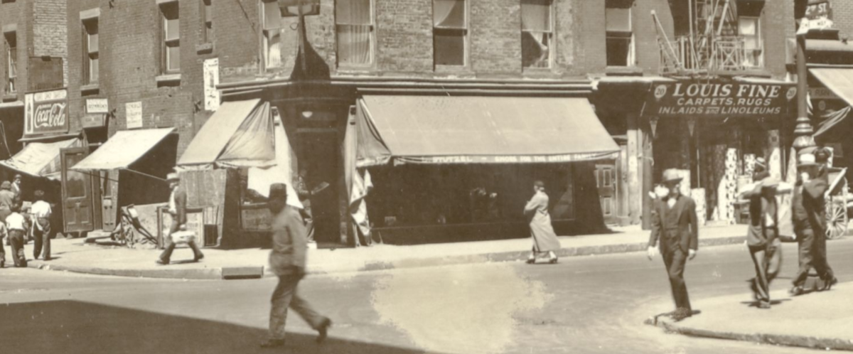 black and white street scene of people striding on an old NYC street
